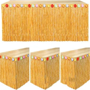 Hawaiian luau grass table skirt with colorful flowers for tropical party decoration details.