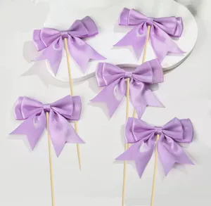 Purple satin ribbon bow cake toppers set for baking party and dessert decoration details.