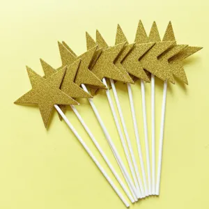 Gold glitter star cake toppers with white sticks, perfect party dessert decoration picks.
