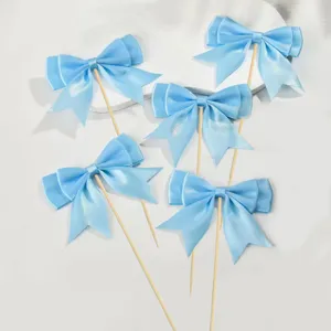 Light blue double layer bow cake toppers detail shot, perfect for baking party and dessert decoration.