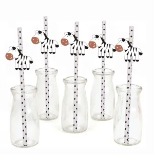 Close-up detail of cute zebra paper straws in glass bottles, perfect for birthday party drink decor.