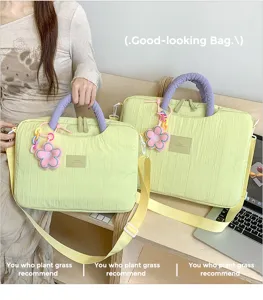 Textured laptop tote bag with cute flower charm and purple handles for daily commute.