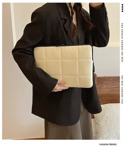 Detailed view of the minimalist quilted laptop sleeve, soft down-feel texture for 13 15 inch.