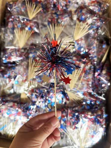 Close-up detail of the 4th of July firework cake topper with metallic stars and tinsel fringe.