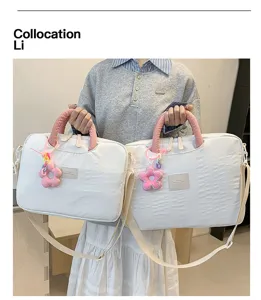 Detailed view of the trendy quilted laptop tote bag with pink handles and floral pendant.