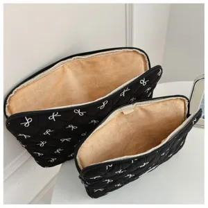 Housse pour ordinateur matelassée noire avec broderie de nœud et doublure en peluche douce.