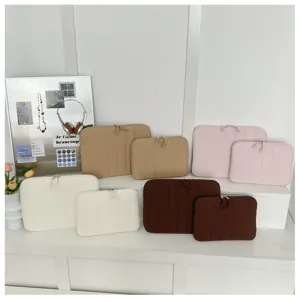 Detailed close-up of minimalist quilted laptop sleeves in multiple colors and sizes.