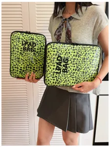 Detail view of trendy transparent leopard print laptop sleeve and tablet bag for daily use.