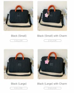 Detailed view of the black pleated laptop tote bag with orange handle and stylish flower pendant.