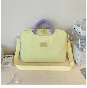 Chic padded laptop bag with vibrant contrast handles, large capacity, perfect for daily commuting.