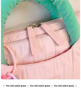 Pink pleated tote bag with green puffy handle and convenient zipper closure for women style
