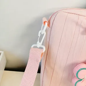 Pink tote bag detail showing detachable shoulder strap, texture fabric and adjustable buckle.