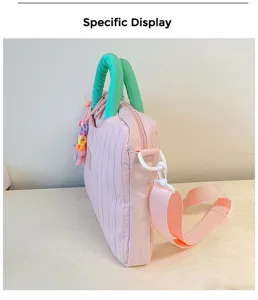 Pink textured laptop tote bag with green handles and stylish shoulder strap for daily use.