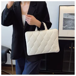 White quilted laptop handbag detail, lightweight protective sleeve with cute heart embossed logo.