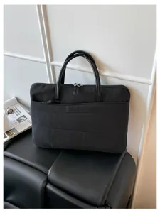 Detailed view of the Korean style quilted 14-inch laptop handbag, slim and shockproof design.