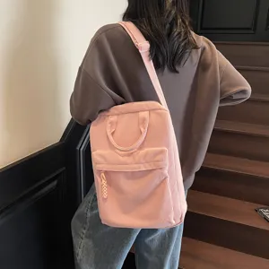 Pink corduroy backpack for women, casual school bookbag with laptop compartment and front pocket.