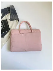 Pink quilted laptop sleeve detail view, 14 inch slim protective computer bag design.