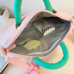 Detailed view of pink green tote bag showing interior mesh pockets and spacious storage design.