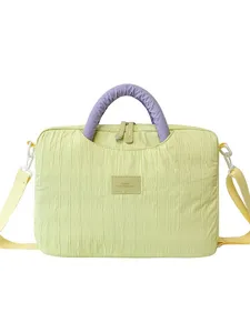 Stylish textured laptop tote bag with purple handles and shoulder strap for daily office commute.