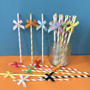 Cannucce di carta a righe colorate con fiocchi in raso per feste di compleanno e tavoli da dessert.
