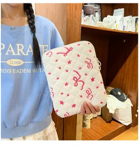 Cute quilted laptop sleeve with pink bow and star embroidery, stylish tablet storage bag.