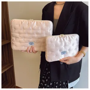 Detail shot of Korean style quilted satin laptop sleeve with cute bow embroidery for women