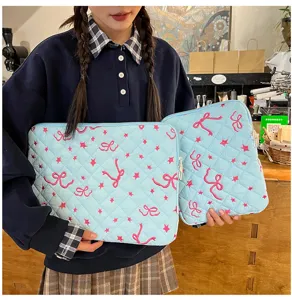 Cute quilted laptop sleeve with pink bow and star embroidery, stylish and large capacity.