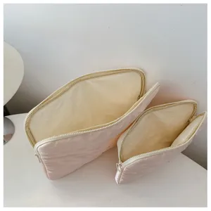 Pink quilted bow embroidered laptop sleeve, soft fleece inner lining, portable storage.