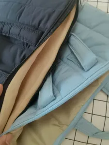 Detailed view of quilted laptop sleeve bag with soft fleece interior lining and secure zipper.