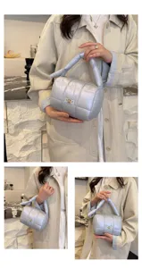 Puffy quilted cosmetic bag, lightweight handbag with top handle for daily travel use.