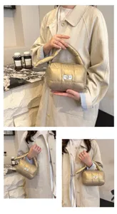 Metallic gold quilted puff cosmetic bag, portable travel toiletry storage pouch detail view.