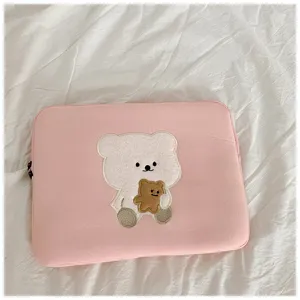 Pink laptop sleeve with cute embroidered bear design, soft inner case for 11 to 13 inch tablets.