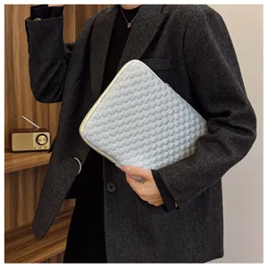 Minimalist quilted laptop detail, soft protective inner case for tablet and notebook.