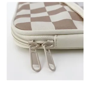 Close up detail of the chic checkered tablet sleeve zipper and soft fleece fabric design.
