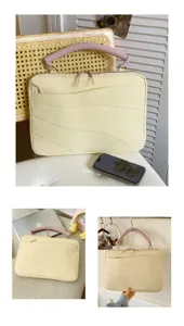 Close-up detail of the chic yellow laptop sleeve with pink handle and stylish wavy quilted texture.
