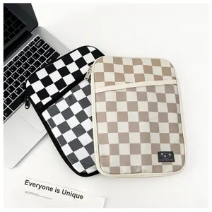 Detailed view of plush padded checkerboard tablet sleeve with secure zipper and koala patch.