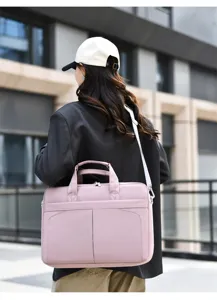 Pink minimalist laptop shoulder bag detail shot, professional commuting style accessory.