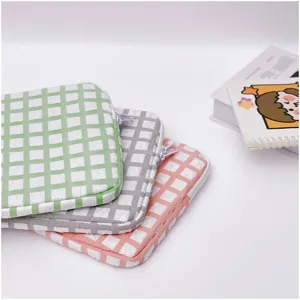Detailed view of colorful quilted grid laptop sleeves, soft plush lining for tablet protection.