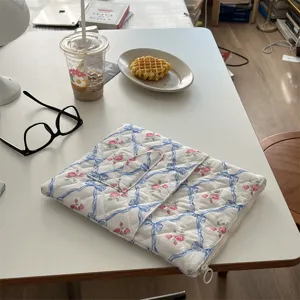 Floral quilted laptop sleeve with elegant blue ribbon bows for 11 13 15 inch tablets.