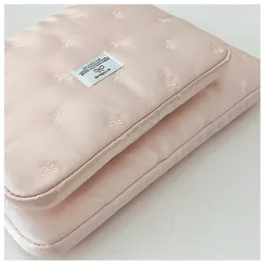 Pink quilted laptop sleeve with embroidered bows, portable 14 inch protective computer bag.