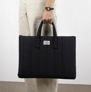 Black quilted laptop bag for 13 inch notebook and 11 inch tablet with dual handles.