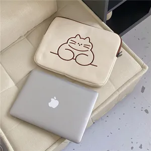 Minimalist beige laptop sleeve with cute cat embroidery, soft protective tablet bag for daily use.