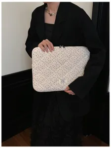 Detailed view of the Korean-style quilted floral laptop sleeve holding by model safely.