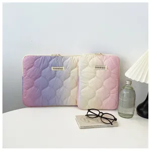Gradient quilted laptop sleeve detail view, soft padded inner bag with dual zipper design.