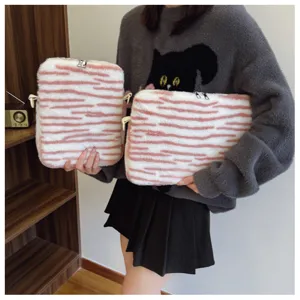 Plush pink striped laptop sleeve, soft furry tablet case, cute fluffy protective bag for daily use.