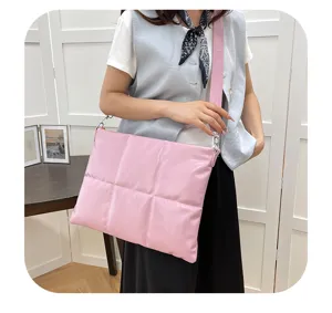 Puffer laptop crossbody bag detail view, soft quilted material for 15.6 inch notebook.