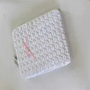 White quilted tablet sleeve with cute pink bow detail, soft pouch for 11 13 inch laptop.