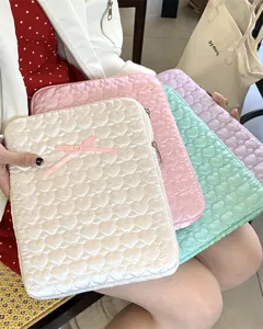 Detailed view of cute quilted heart iPad sleeve with bow in multiple pastel colors.