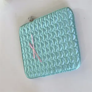 Quilted mint green iPad sleeve with cute pink ribbon bow, soft padded tablet storage pouch.