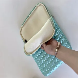 Detailed view of the cute quilted tablet sleeve interior lining and soft plush protection.